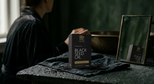 Ethiopian black seed oil product box on a stone surface in a premium skincare ritual scene
